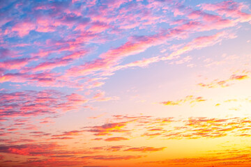 Sunset or sunrise sky with a vibrant gradient of orange, gold, and soft blue. Clear atmosphere with wispy clouds. Peaceful, natural light background. hope, freedom, new day and inspirational Concepts