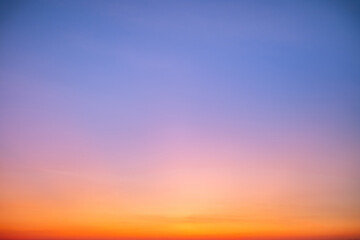 Sunset or sunrise sky with a vibrant gradient of orange, gold, and soft blue. Clear atmosphere with wispy clouds. Peaceful, natural light background. hope, freedom, new day and inspirational Concepts