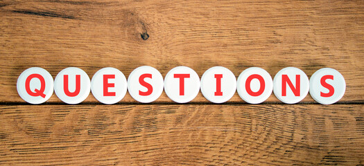 Question questions symbol. Concept word Questions on beautiful white circles. Beautiful wooden background. Business education support questions concept. Copy space.