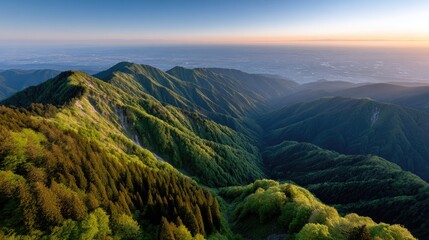 View of green mountains, city in the distance, and rain clouds above, showcasing nature and the high altitude near Jodo Shrine