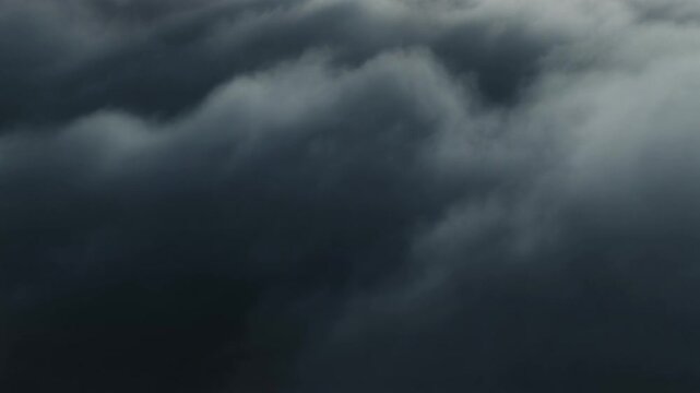 A thick, foreboding blanket of stormy dark clouds covers the sky, creating a heavy and dramatic atmosphere before a downpour