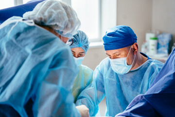Close up surgeon hands holding syringe during preoperative injection in operating room