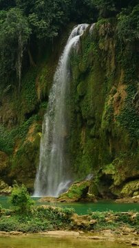 a view of the Bản Giốc Waterfall or  Detian Falls known for its emerald water and lush green cliffs