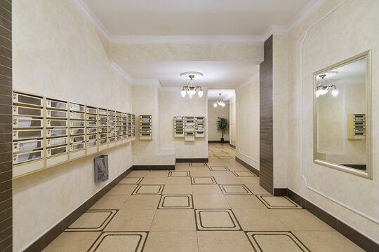 modern apartment lobby with mailboxes and polished tiles