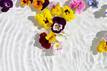 Beautiful flowers floating on clear water, sparkling in the sunlight.
