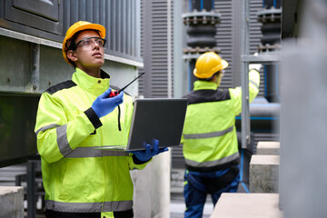Engineers inspecting a power plant for maintenance and troubleshooting issues. They are using a...