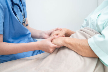 Asian doctor checking and treat elderly woman patient health in hospital.