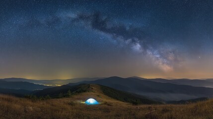 Fototapeta premium tent. A glowing tent beneath the Milky Way in a serene mountain landscape, capturing tranquil camping under natural light. travel magazines.