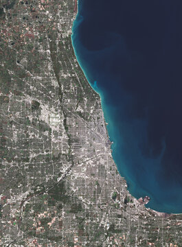 High-resolution satellite view of Chicago illustrating dense urban infrastructure, transportation networks, and Lake Michigan. This image supports discussions on sustainable megacities