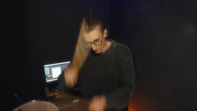 Live streaming drum performance with intense energy and dramatic lighting