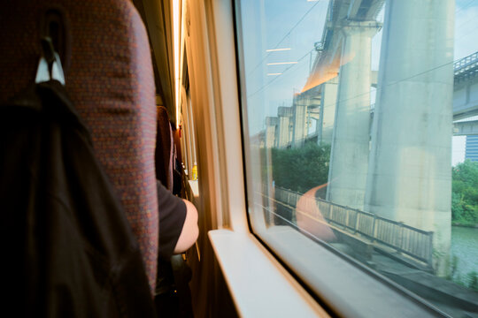 View from a train window showing a bridge and surrounding greenery during a ride. Chengdu, Sichuan, China