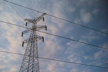 Transmission tower standing against a blue sky with scattered clouds. Chengdu, Sichuan, China