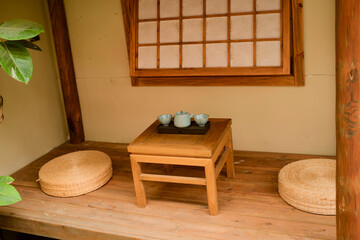 Traditional Japanese tea room with wooden table, cushions, and tea set on a wooden floor. Chengdu, Sichuan, China