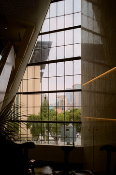 Expansive cityscape view through large window panes in a modern building interior. Chengdu, Sichuan, China