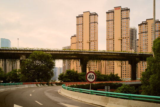 Elevated highway with greenery and tall residential buildings in an urban setting. Chengdu, Sichuan, China