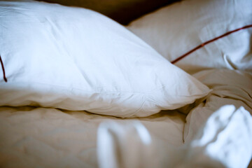 Crisp white pillows and linens on a neatly made bed with soft lighting. Guangzhou, Guangdong, China
