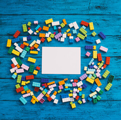 Fototapeta premium Сolourful creative children's background with colored toy bricks