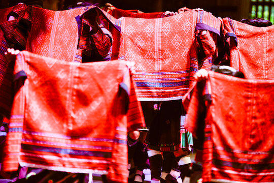 Vibrant red woven textiles displayed with intricate patterns and designs. Longji (Longsheng) Rice Terraces, Longsheng, China