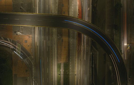 Aerial view of a highway interchange at night with light trails from moving vehicles. Bogota DC, Colombia