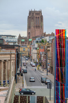 A city street view with historic architecture and a modern art installation in the foreground. Liverpool, England