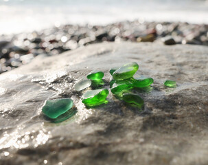 Glass sea pebbles of different colours on shore, beach. Nature and ecology. Background for design.