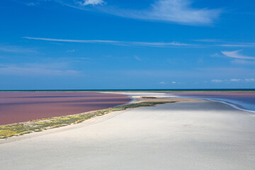 Minimalistic landscape with a pink lake and sea. Sunny day. Crimea.