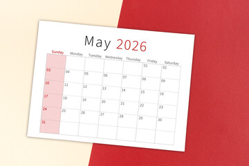 May 2026 calendar page on yellow and red background.
