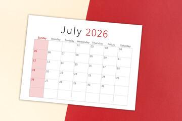 July 2026 calendar page on yellow and red background.