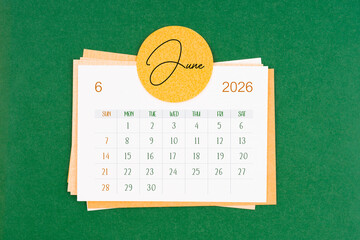 June 2026 calendar page on green background.