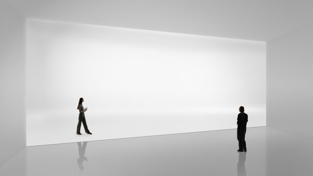 Minimalist artwork with two people facing large white wall. Concept of corporate vision visuals, brand storytelling, executive presentations, strategic communication and innovation workshops.