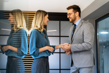 Group of young business people working as a team and communicating in corporate office