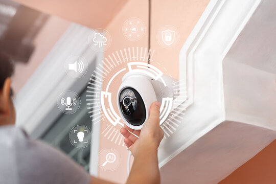 Smart home security system concept with IP camera and AI technology,Asian woman monitor CCTV system, Motion detection, facial recognition, Voice control,Real-time alerts,Network connected surveillance