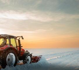 Obraz premium Tractor Snow Blower blowing away heavy snowfall