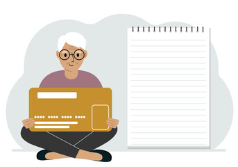 A man sits cross-legged in his hands holding a large credit card next to a close-up notepad for text. Concept of credit card, expense planning, income planning.