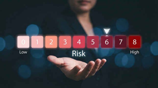 Business professional holding a digital risk assessment scale with management options from low to high risk
