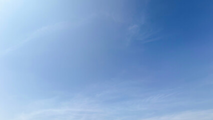 A beautiful blue sky filled with soft white clouds on a bright sunny day