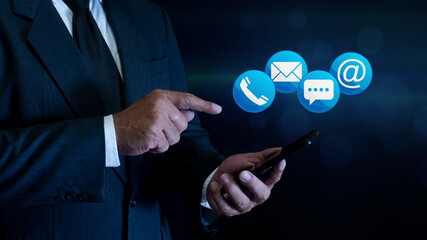 Businessman using smart phone with Contact Info Symbols ( address, phone, email, mobile, call ). contact customer support. contact us concept