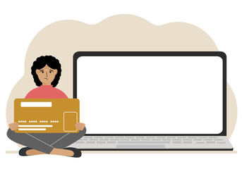 A woman sits cross-legged and holds a large plastic card. Next to the woman is a large laptop with space for text.