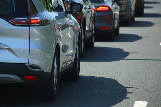 Heavy traffic congestion on highway with cars, tunnels, and traffic signals.