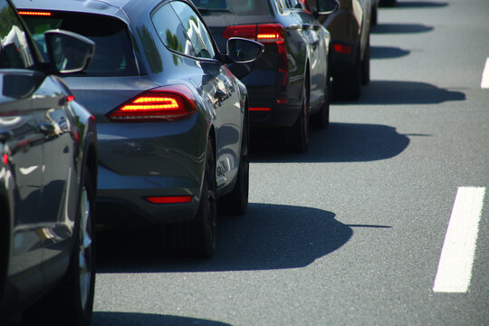 Heavy traffic congestion on highway with cars, tunnels, and traffic signals.