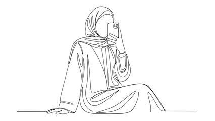 Obraz premium Woman in hijab sitting with smartphone