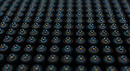 A repeating pattern of tiny glowing blue and orange lights or LEDs on a dark electronic surface