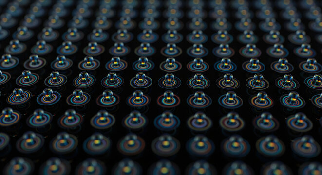 A repeating pattern of tiny glowing blue and orange lights or LEDs on a dark electronic surface - Powered by Adobe
