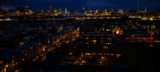 Naklejka premium Ijmuiden Netherlands aerial view at night. Old dancing houses, canals, river channel and ships, canals with bridges, old european city landscape from above.