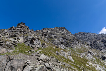 Fototapeta premium Panoramic mountain view of the Mont-Cenis Massif ,Savoie, French Alps, featuring rugged peaks, alpine meadows, and natural high-altitude scenery.