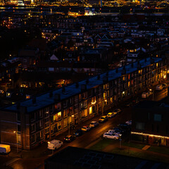 Obraz premium Ijmuiden Netherlands aerial view at night. Old dancing houses, canals, river channel and ships, canals with bridges, old european city landscape from above.