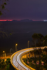long-exposure photograph captures the dramatic curves of the Costa Verde highway as it winds along the base of the cliffs in Miraflores, Lima, Peru. With Bridge of &ldquo;la Paz&rdquo;