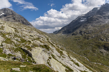 Fototapeta premium Panoramic mountain view of the Mont-Cenis Massif ,Savoie, French Alps, featuring rugged peaks, alpine meadows, and natural high-altitude scenery.