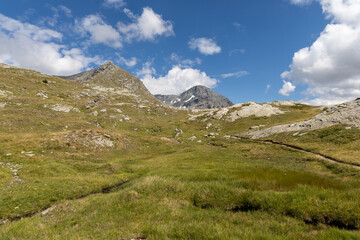 Fototapeta premium Panoramic mountain view of the Mont-Cenis Massif ,Savoie, French Alps, featuring rugged peaks, alpine meadows, and natural high-altitude scenery.
