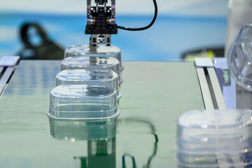 Plastic Food Containers on Conveyor Belt from Injection Molding Machine